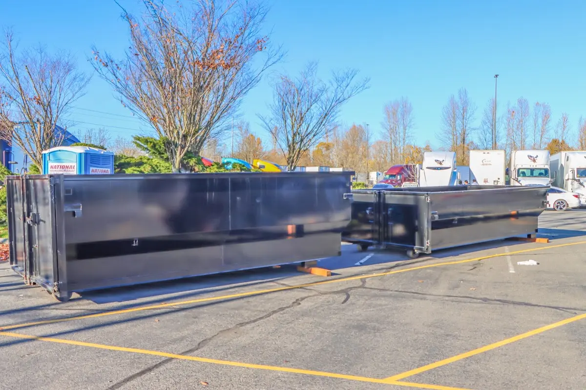 Professional dumpster rental service with roll-off container on residential driveway in Yelm